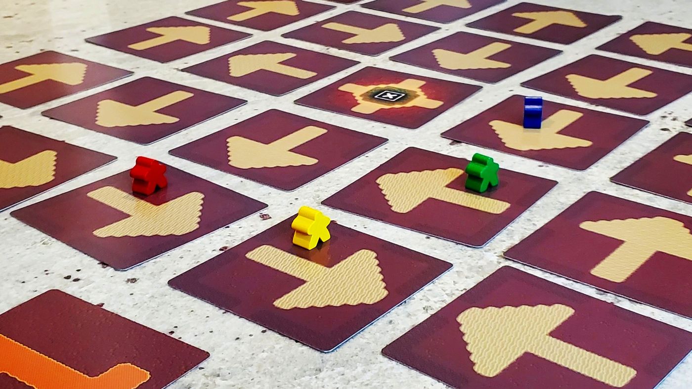 Spelunker meeples moving along the arrows of the game board